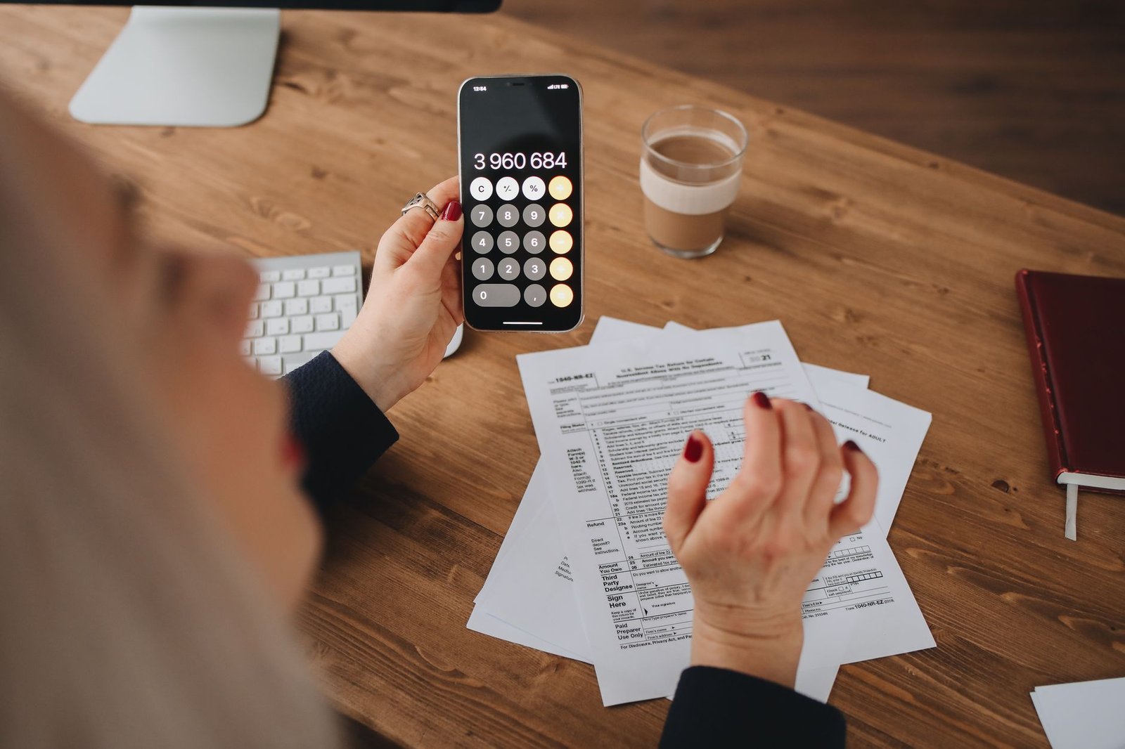 Hands calculating monthly benefits affected by the yearly cost-of-living adjustment